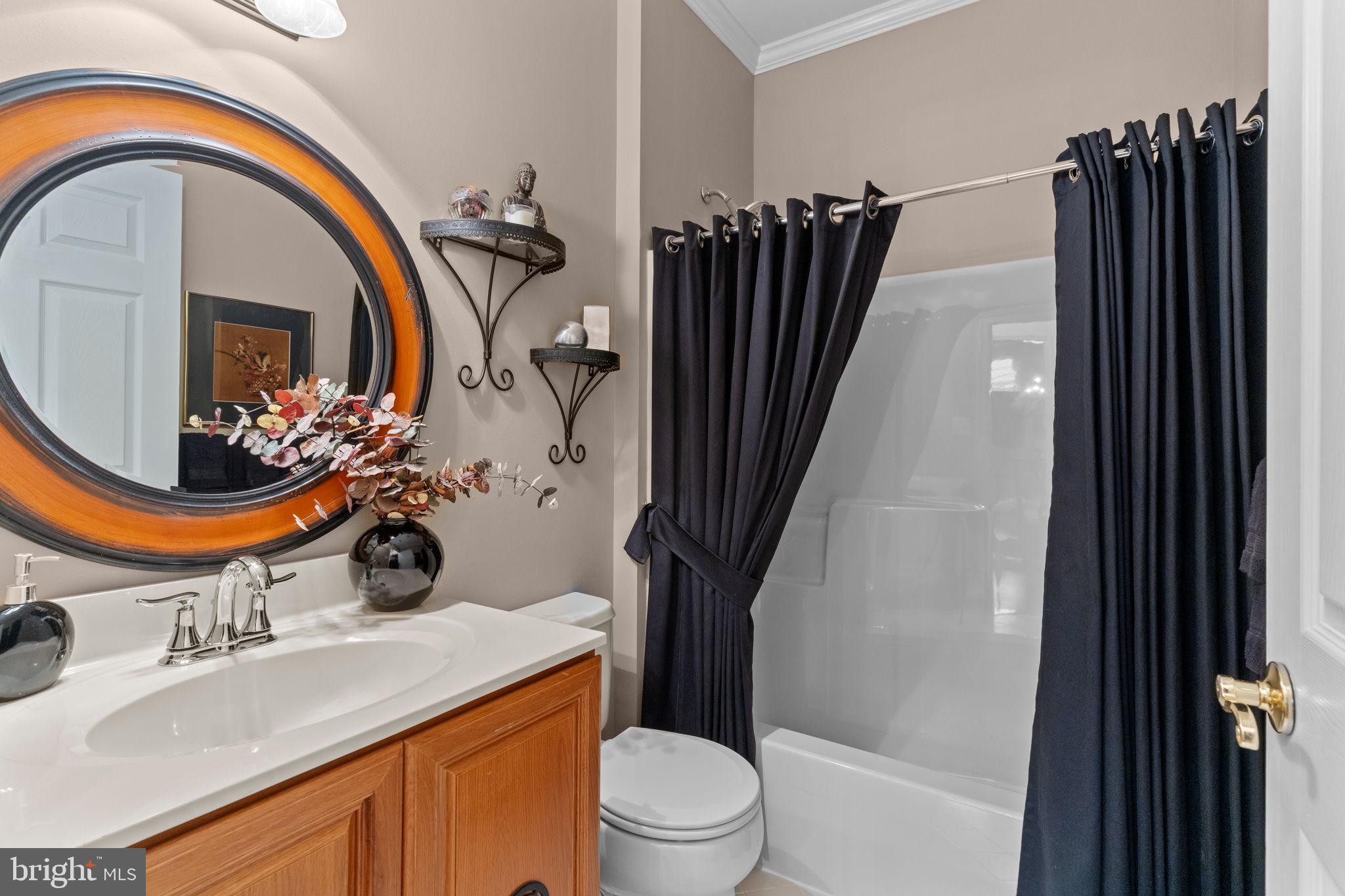 613 Bellflower Road Langhorne, PA 19047 - Photo 23 of 28 a bathroom with a sink a toilet and a mirror