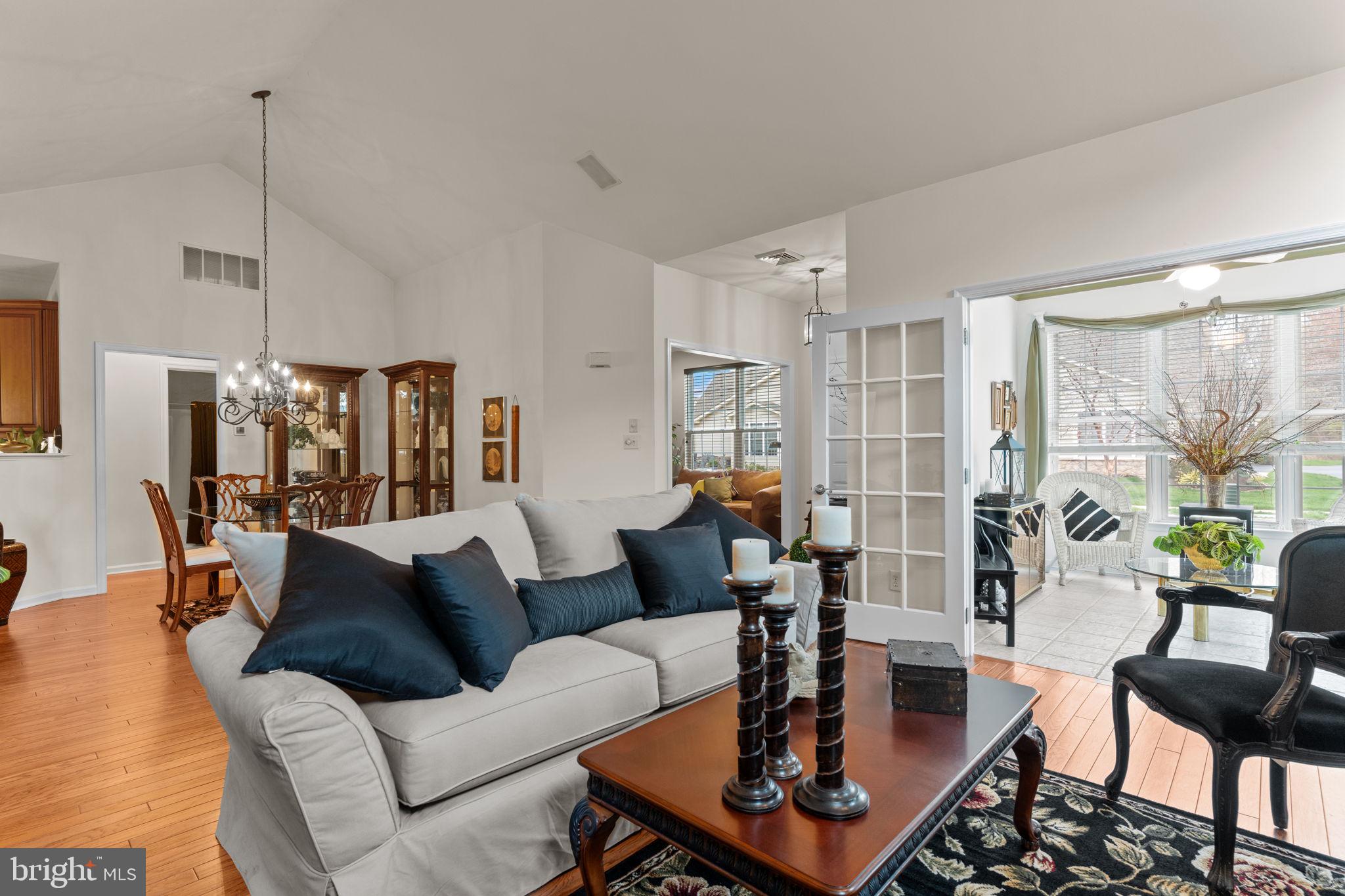 613 Bellflower Road Langhorne, PA 19047 - Photo 7 of 28 a living room with furniture a table and a chandelier