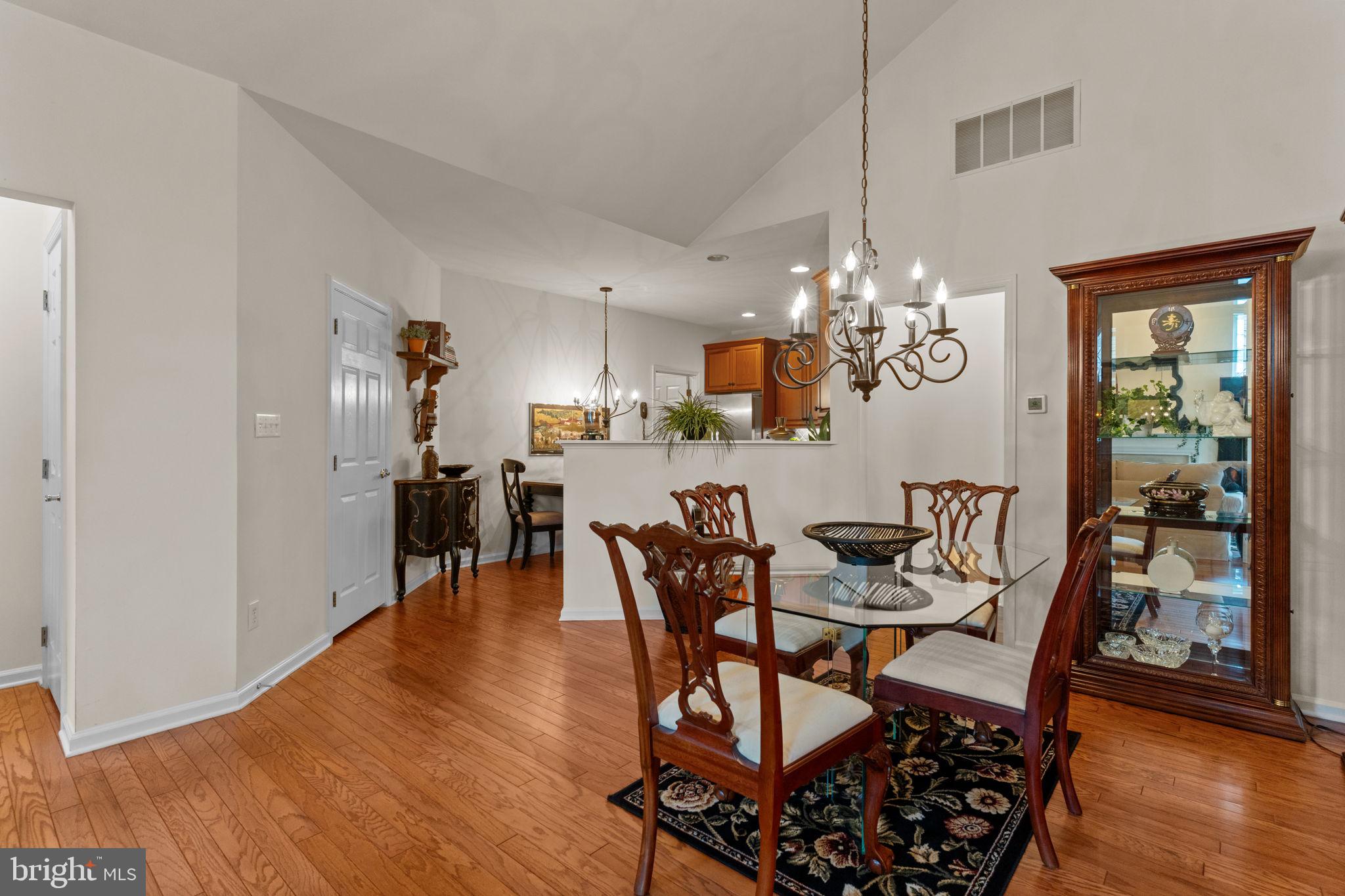 613 Bellflower Road Langhorne, PA 19047 - Photo 9 of 28 a view of a dining room with furniture a chandelier and wooden floor
