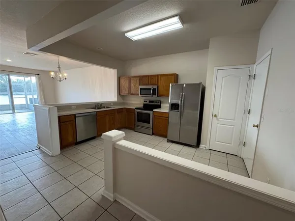 a kitchen with stainless steel appliances granite countertop a refrigerator and a stove