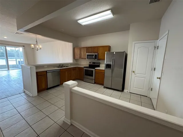 a kitchen with stainless steel appliances granite countertop a refrigerator and a stove