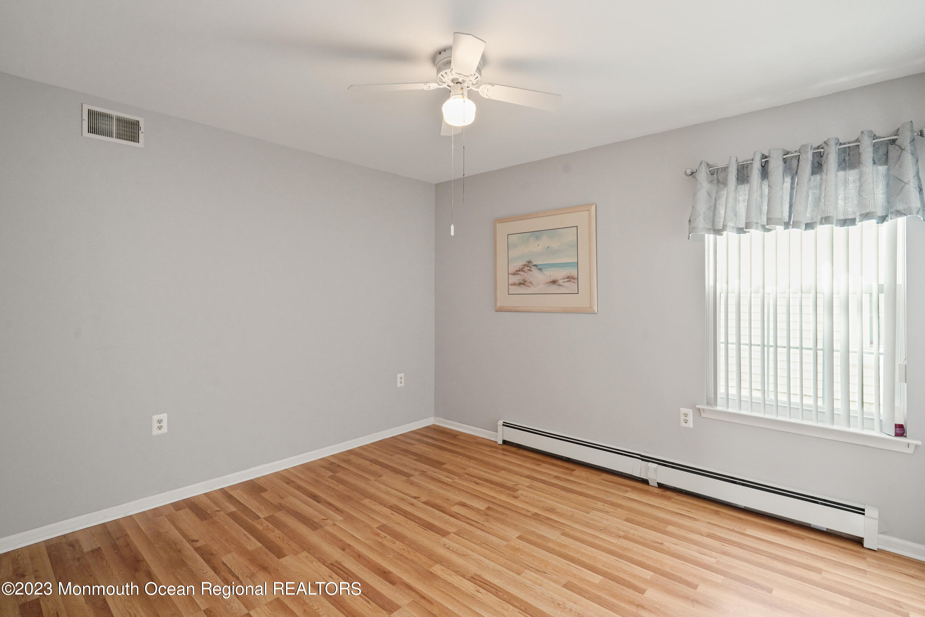 7 Portebello Road Jackson, NJ 08527 - Photo 30 of 49 wooden floor in an empty room with a window
