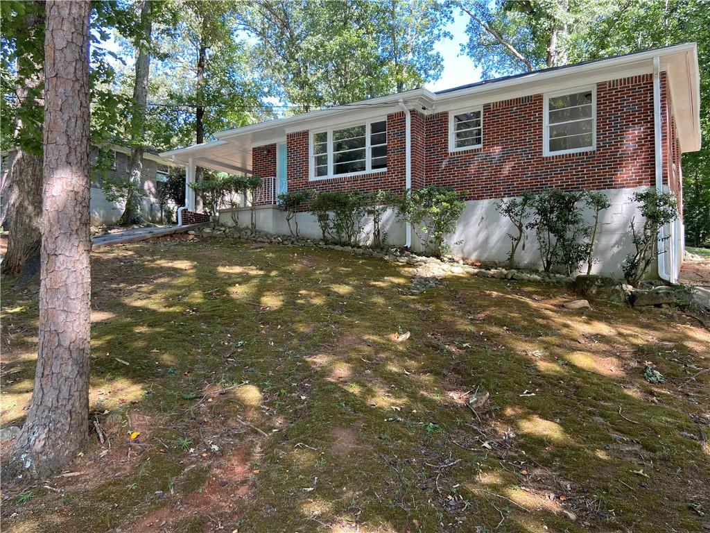 2548 Riggs Drive East Point, GA 30344 - Photo 1 of 1 Ranch style home sits above street level on wooded, sloping yard