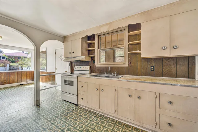 a kitchen with granite countertop white cabinets and white appliances