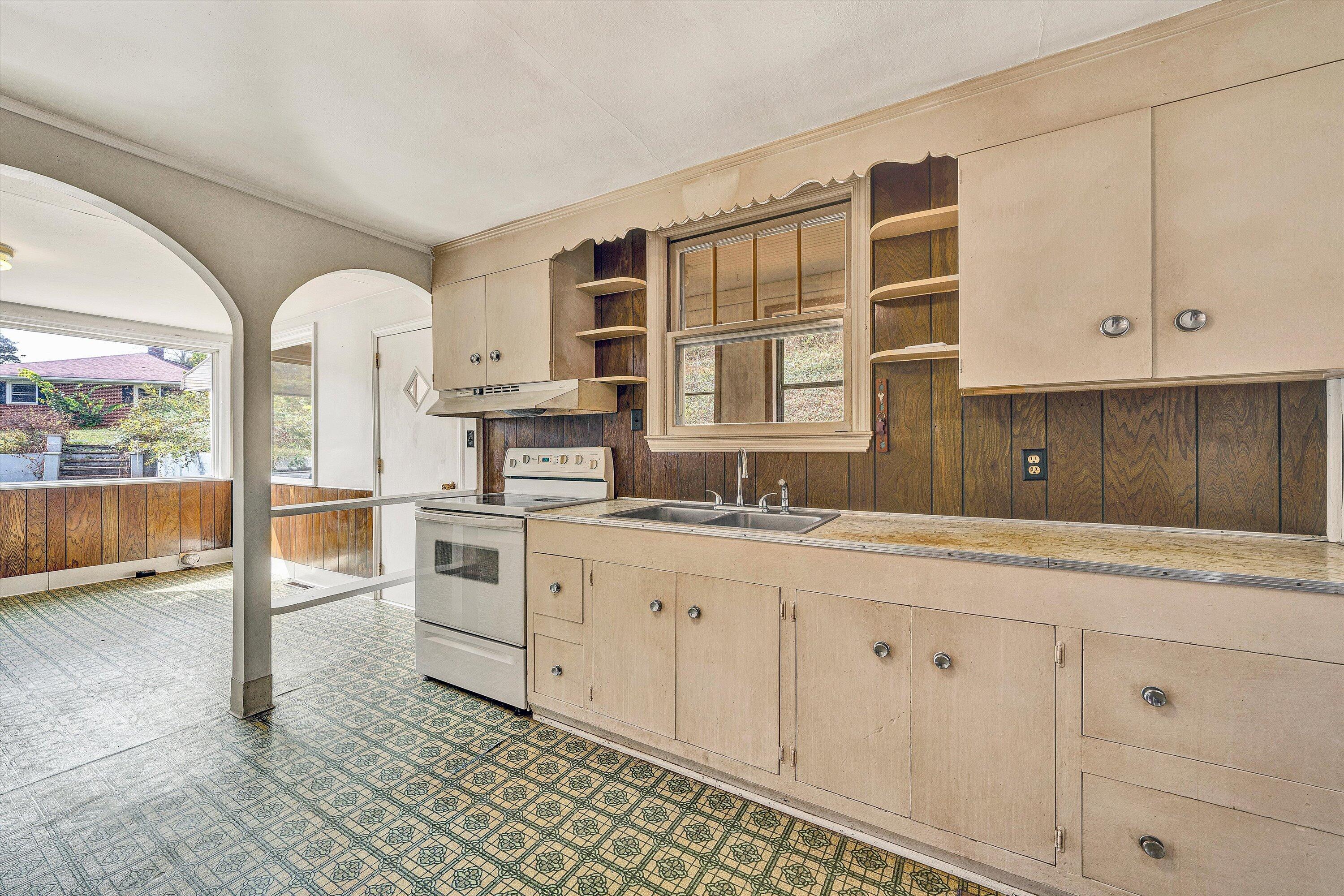3145 Doe Run Road Rocky Mount, VA 24151 - Photo 11 of 38 a kitchen with granite countertop white cabinets and white appliances