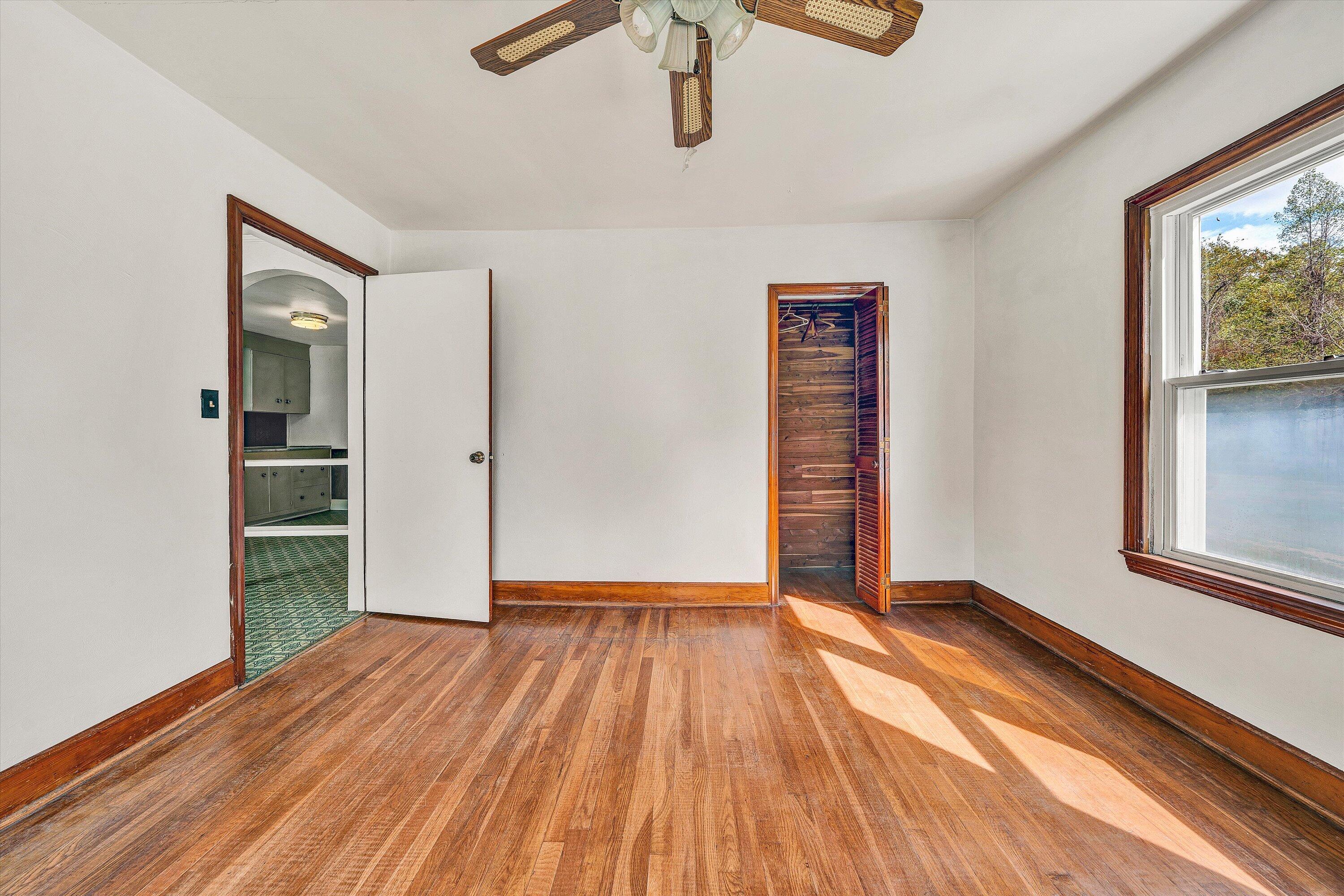 3145 Doe Run Road Rocky Mount, VA 24151 - Photo 16 of 38 an empty room with wooden floor and windows