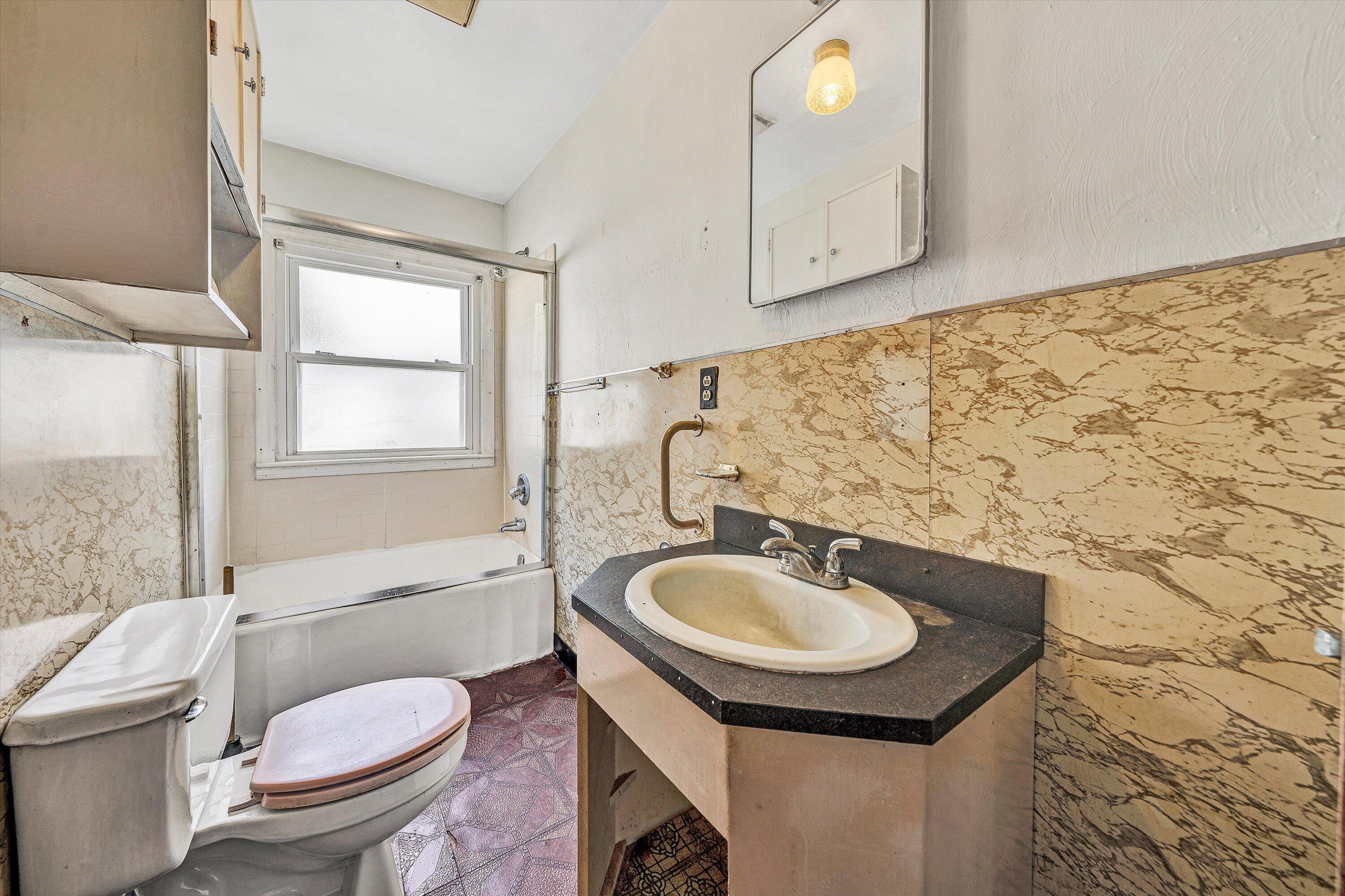 3145 Doe Run Road Rocky Mount, VA 24151 - Photo 18 of 38 a bathroom with a sink toilet a mirror and shower