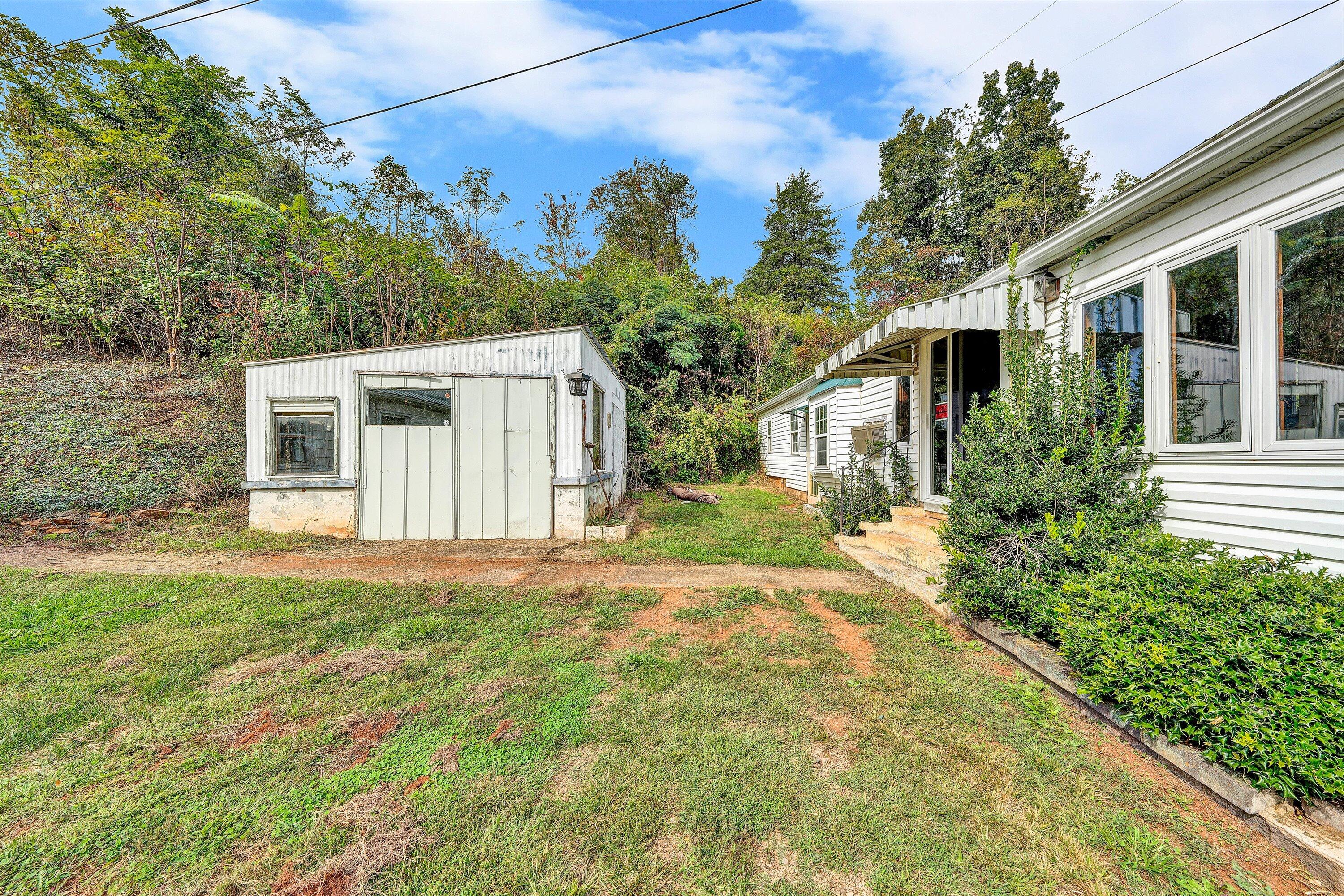 3145 Doe Run Road Rocky Mount, VA 24151 - Photo 21 of 38 a front view of a house with a garden
