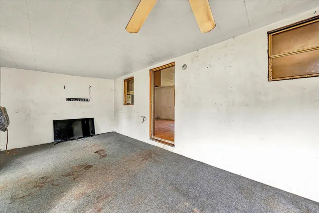 a view of empty room with a fireplace