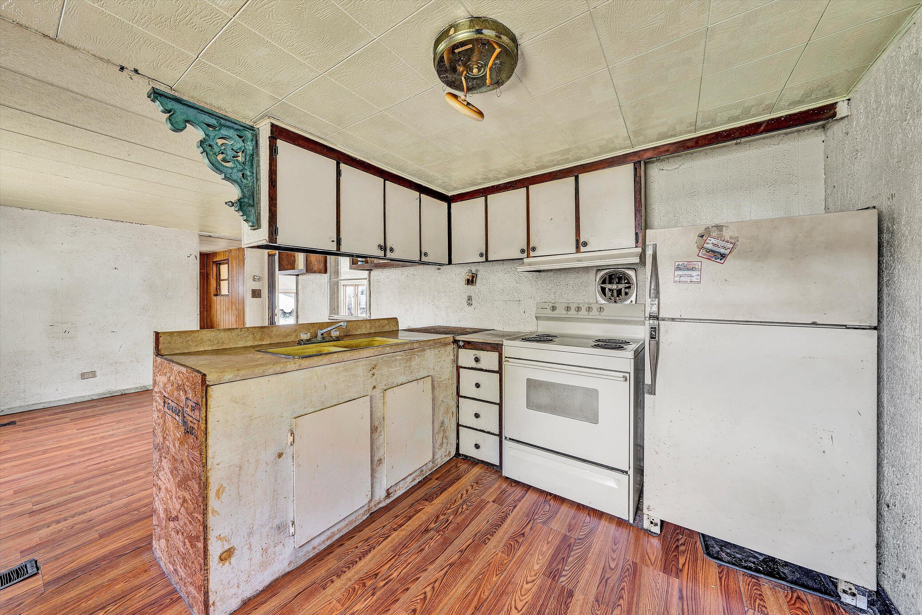 3145 Doe Run Road Rocky Mount, VA 24151 - Photo 26 of 38 a kitchen with a stove cabinets and a wooden floor