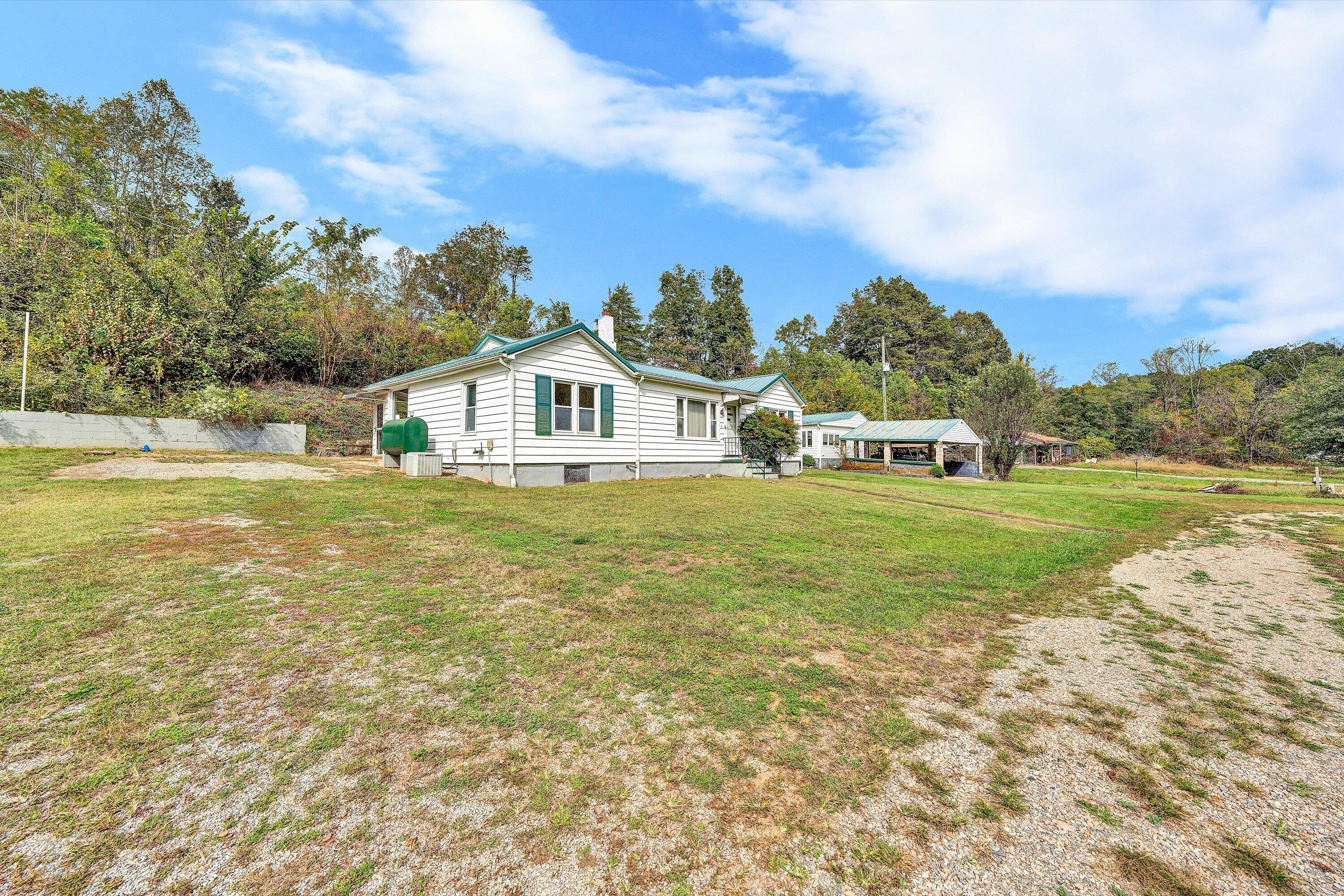 3145 Doe Run Road Rocky Mount, VA 24151 - Photo 3 of 38 a view of house with garden and trees