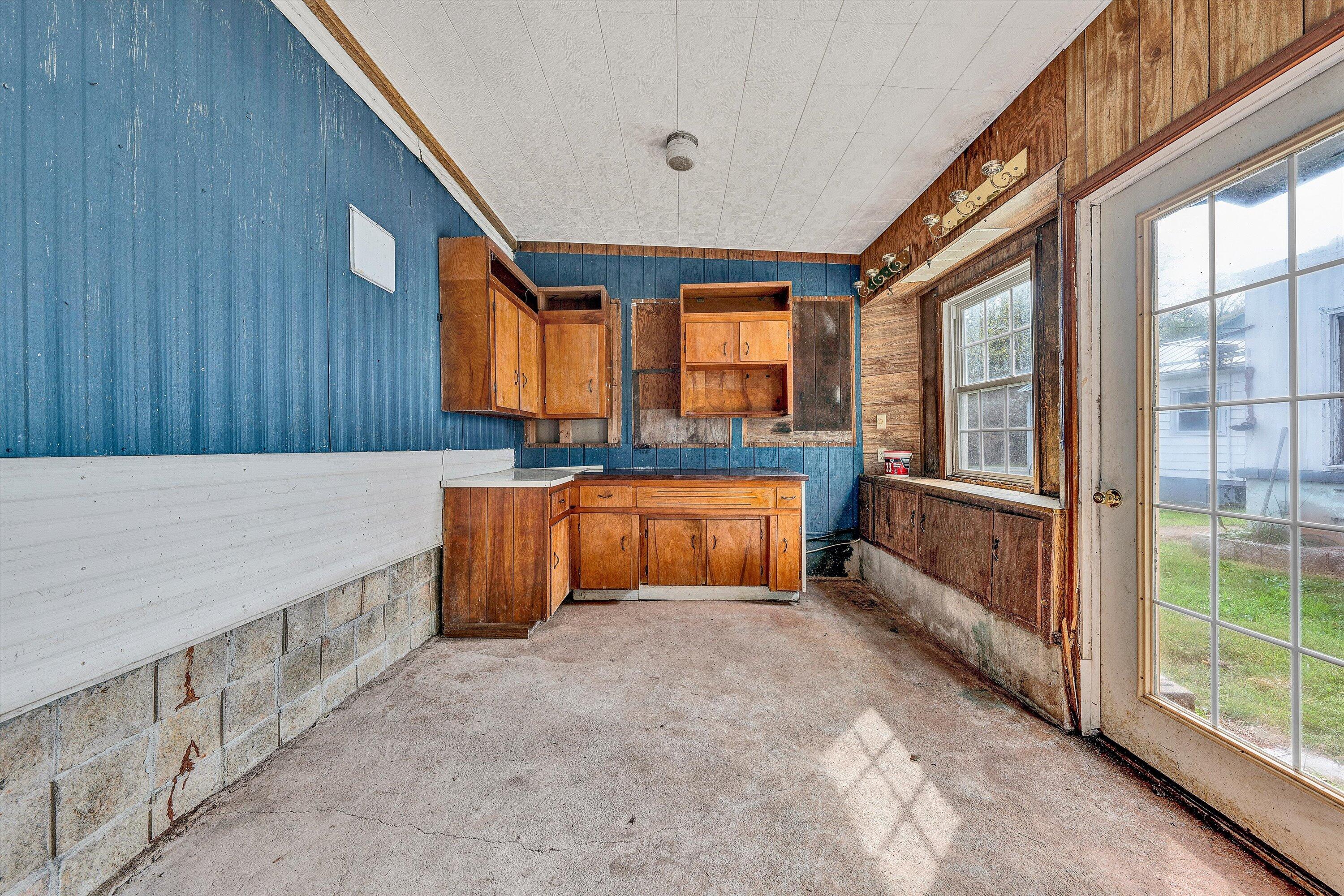 3145 Doe Run Road Rocky Mount, VA 24151 - Photo 32 of 38 a kitchen with granite countertop a sink and a refrigerator