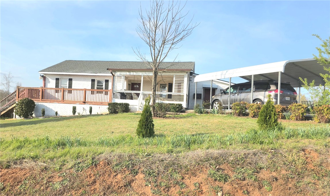 This charming home features a lovely deck and a convenient carport for effortless outdoor living.