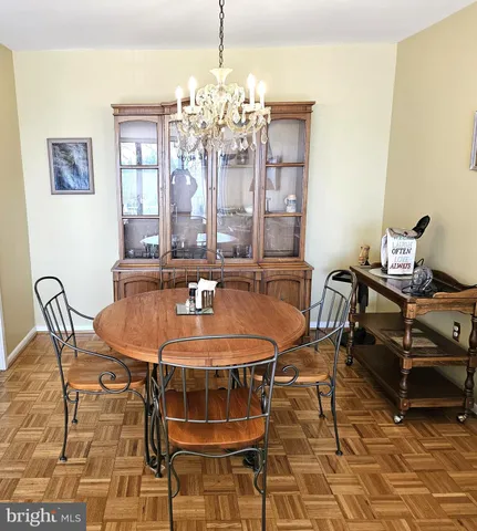 a dining room with furniture and chandelier