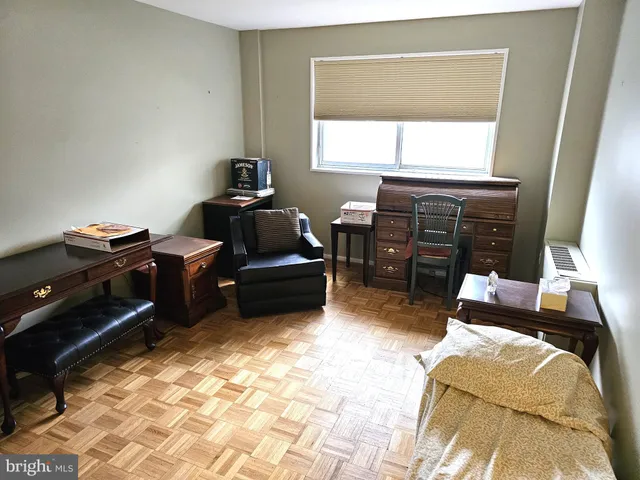 a bedroom with furniture and a window
