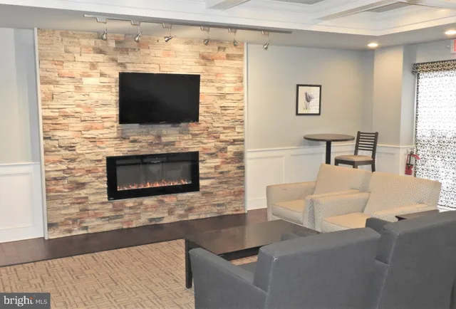 a living room with a fireplace and a flat screen tv