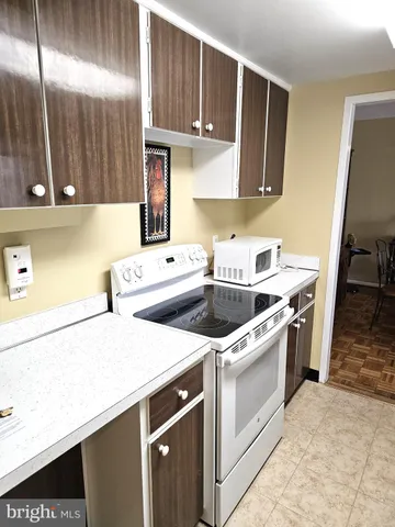 a kitchen with a sink a stove and cabinets