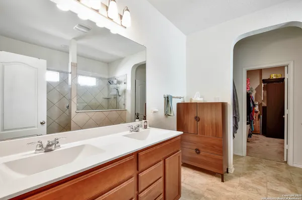 a bathroom with a sink double vanity and a mirror