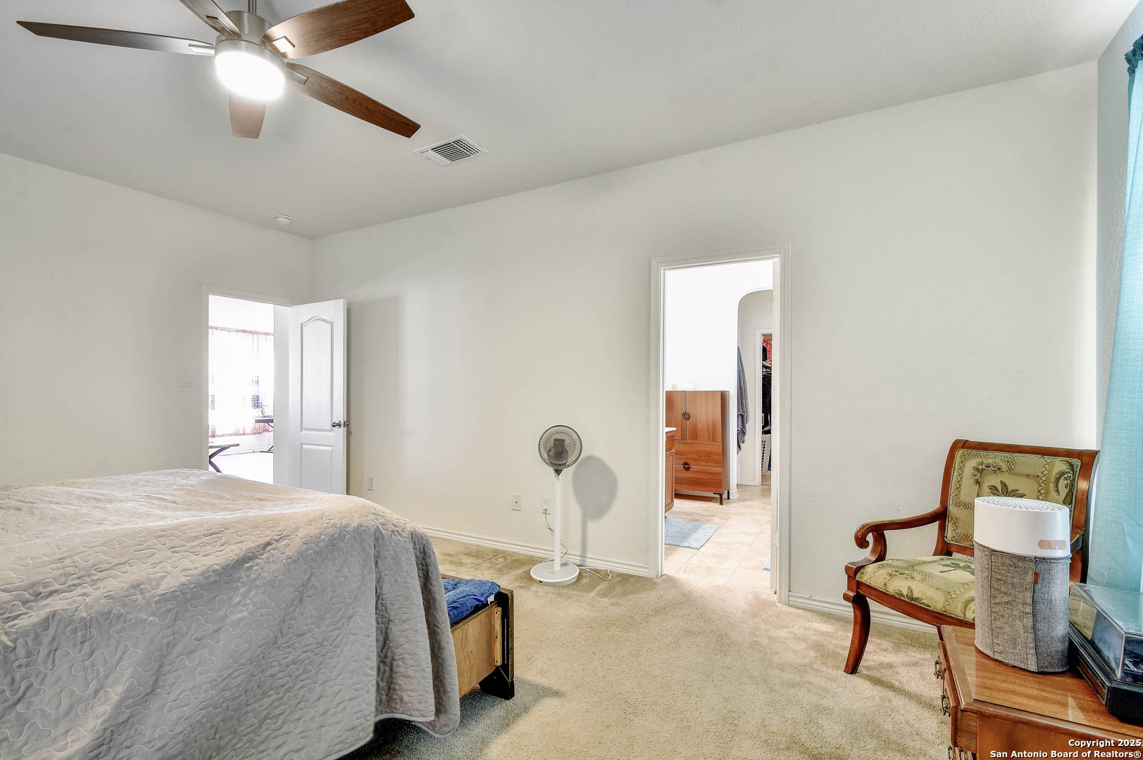 145 Rustic Universal City, TX 78148 - Photo 18 of 25 a bedroom with a bed and a chandelier