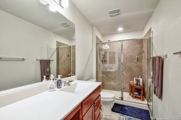 a bathroom with a double vanity sink toilet and shower