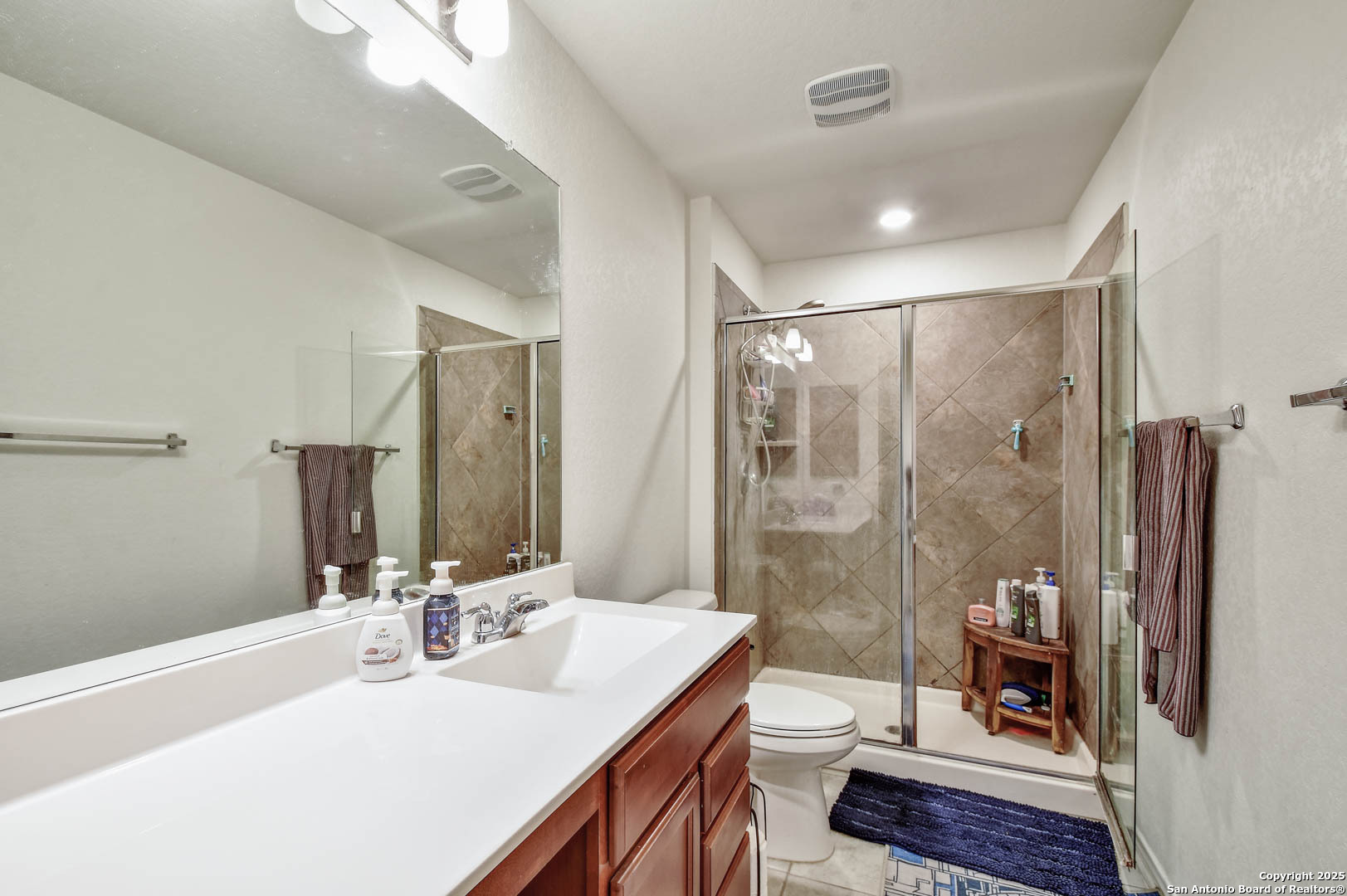 145 Rustic Universal City, TX 78148 - Photo 24 of 25 a bathroom with a double vanity sink toilet and shower