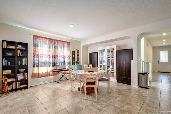a dining room with furniture and a book shelf