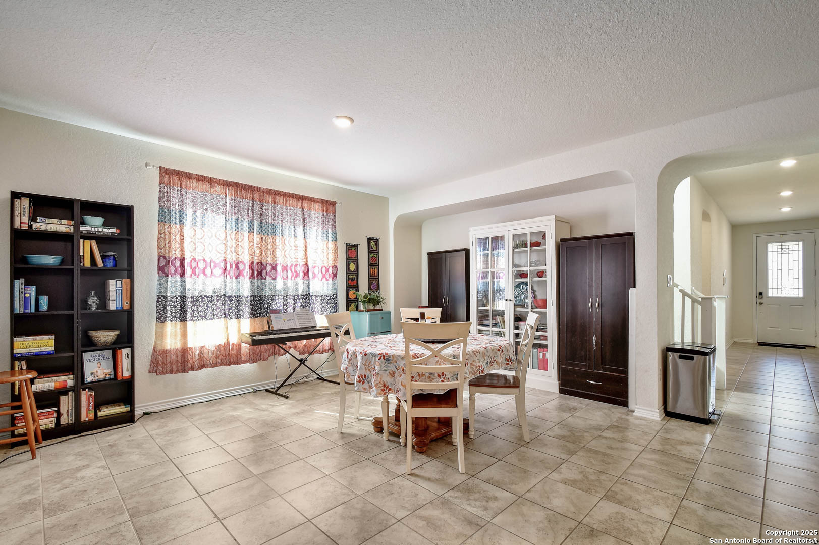 145 Rustic Universal City, TX 78148 - Photo 8 of 25 a dining room with furniture and a book shelf