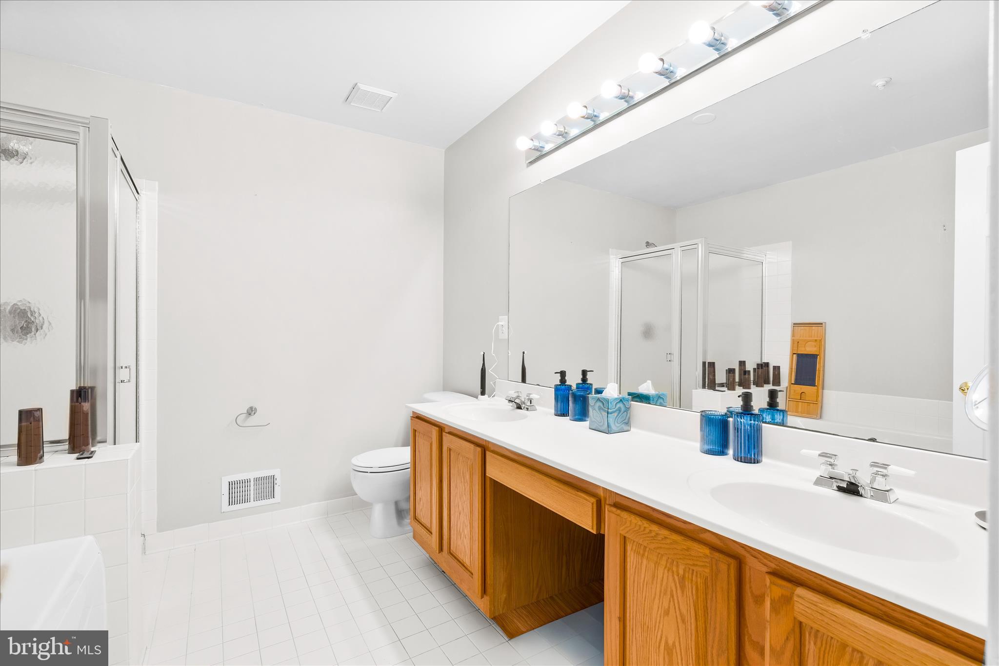 2442 Rippling Brook Road Frederick, MD 21701 - Photo 35 of 85 a spacious bathroom with a double vanity sink a mirror and a toilet
