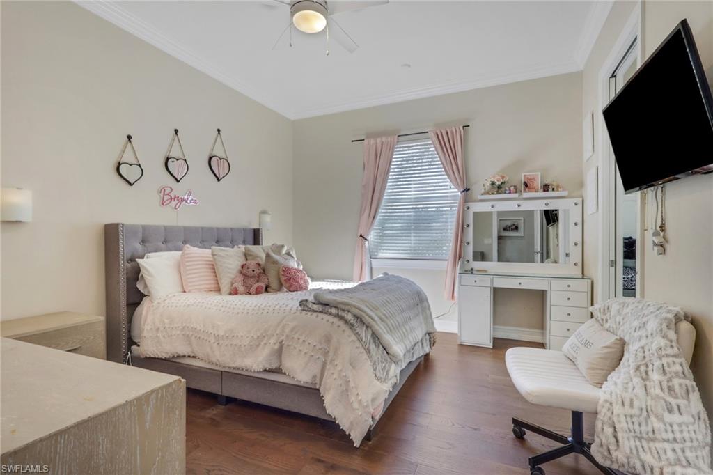 5074 Rustic Oaks Circle Naples, FL 34105 - Photo 25 of 38 a bedroom with a bed and a flat screen tv