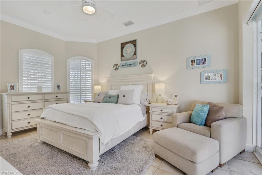 5074 Rustic Oaks Circle Naples, FL 34105 - Photo 26 of 38 Bedroom with ornamental molding and a ceiling fan