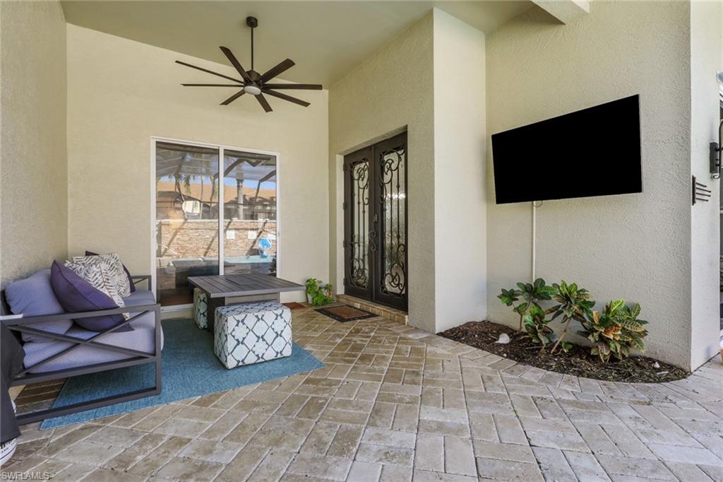 5074 Rustic Oaks Circle Naples, FL 34105 - Photo 29 of 38 a living room with furniture and a flat screen tv