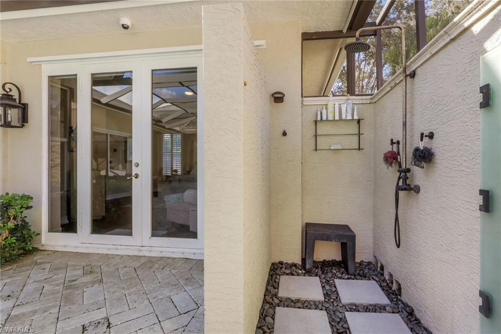 5074 Rustic Oaks Circle Naples, FL 34105 - Photo 33 of 38 Doorway to property with french doors, a patio, and stucco siding