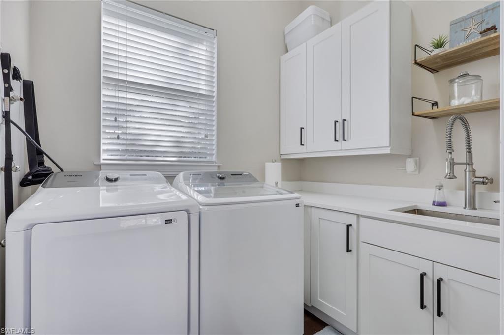 5074 Rustic Oaks Circle Naples, FL 34105 - Photo 37 of 38 Washroom featuring washing machine and dryer and cabinet space