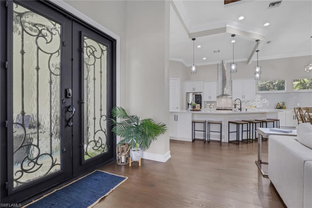 5074 Rustic Oaks Circle Naples, FL 34105 - Photo 4 of 38 Foyer with dark wood-type flooring, french doors, crown molding, and recessed lighting