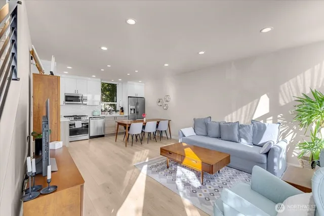 a living room with furniture and kitchen view