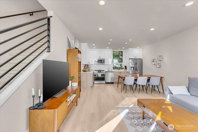 a living room with lots of furniture and kitchen view