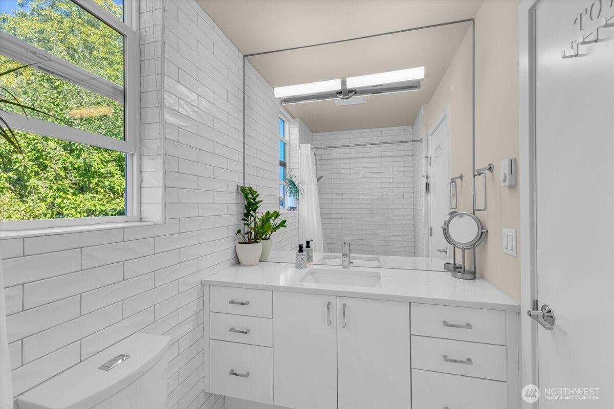 1602 East Marion Street Seattle, WA 98122 - Photo 15 of 28 a bathroom with a sink and a mirror