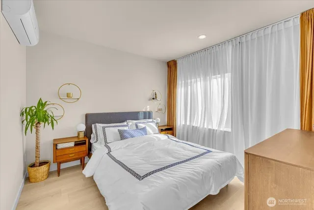 a bedroom with a bed and a potted plant