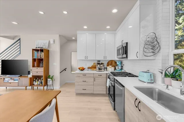 a kitchen with microwave a stove and cabinets