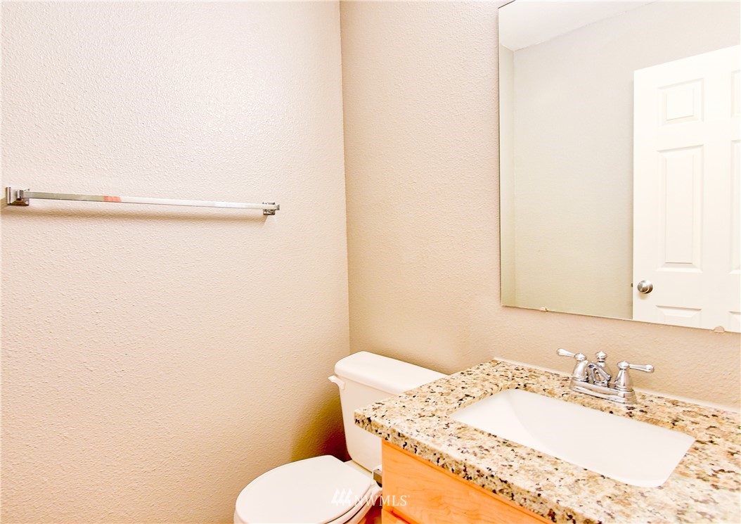 6741 Southeast 4th Street Renton, WA 98059 - Photo 22 of 27 a bathroom with a granite countertop sink and a mirror