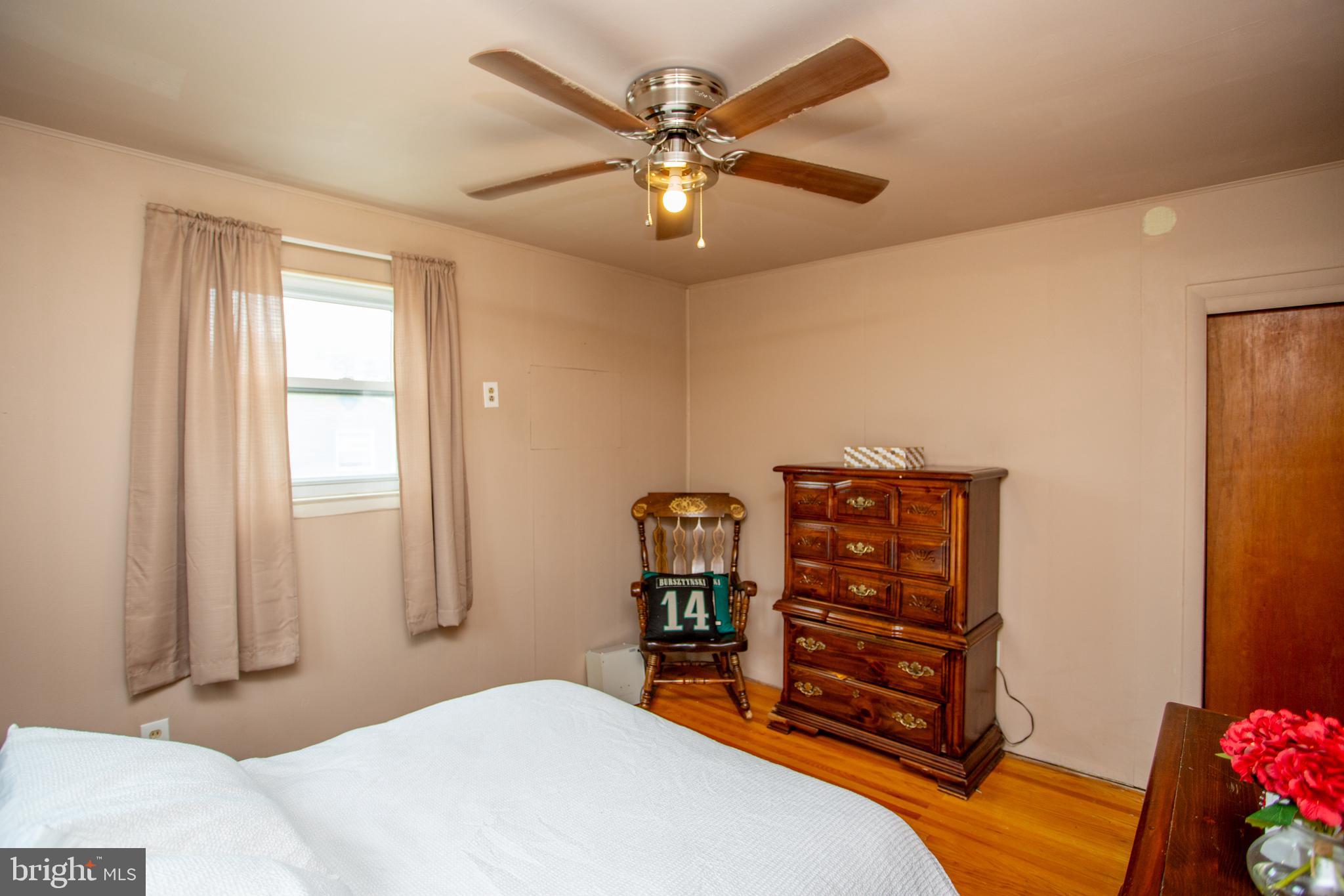 1264 Tulip Road Warminster, PA 18974 - Photo 14 of 21 a bedroom with a bed and a chandelier