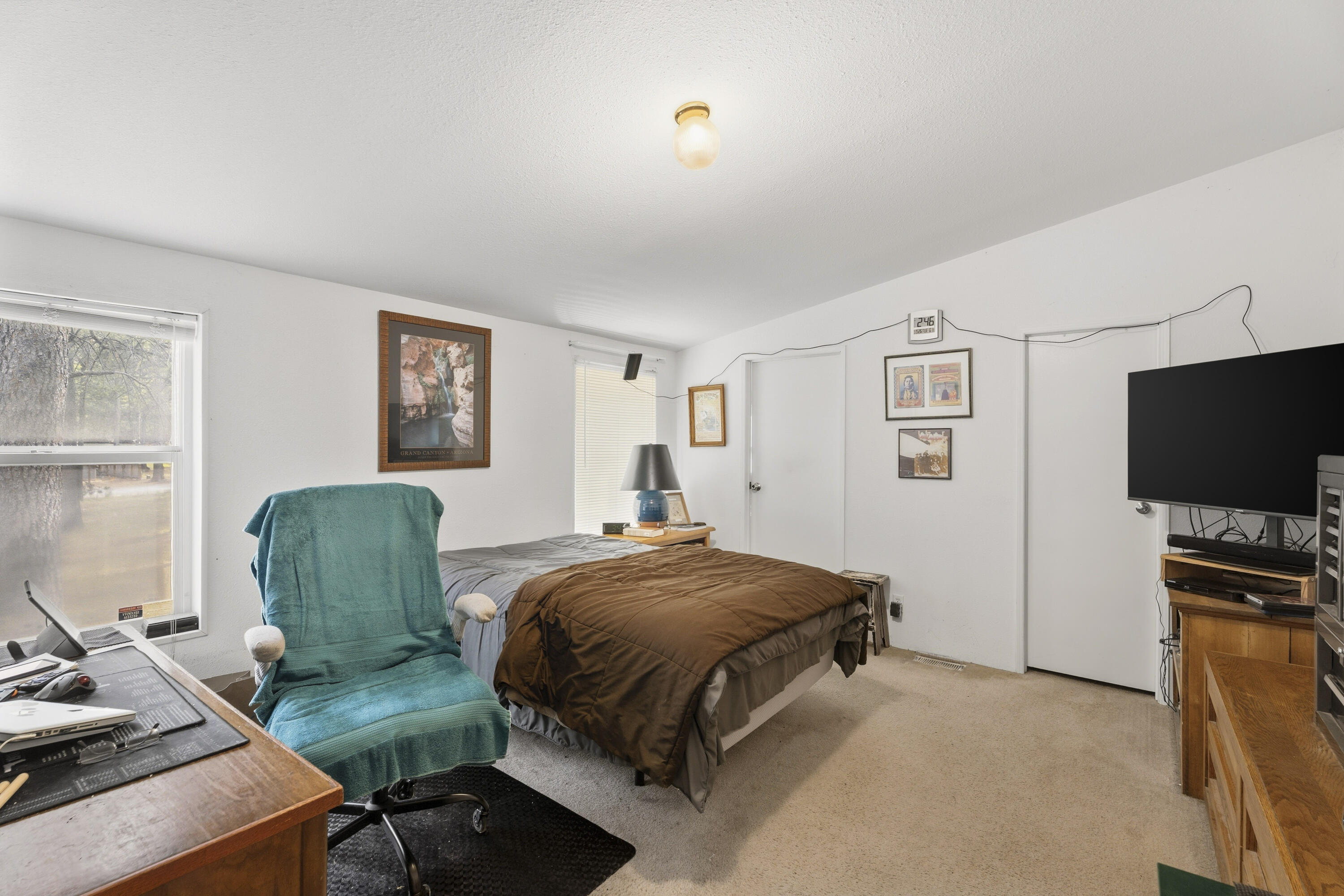 16928 Covina Road Bend, OR 97707 - Photo 23 of 48 a bedroom with a bed and a chair