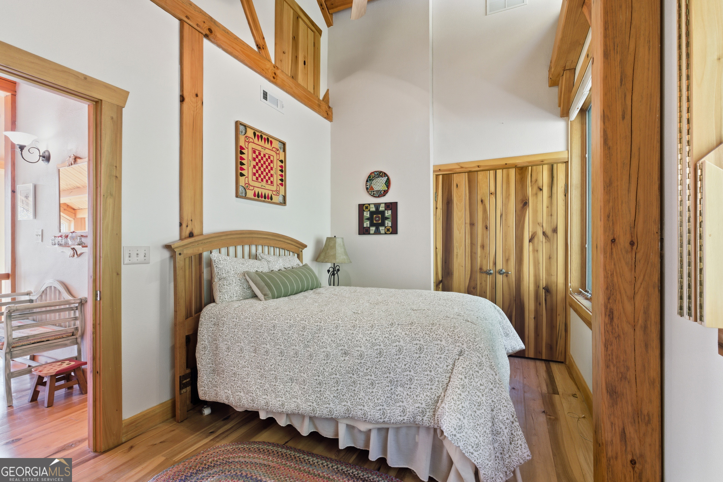 526 Grandaddy Still Road Scaly Mountain, NC 28775 - Photo 30 of 65 a bedroom with a bed and wooden floor