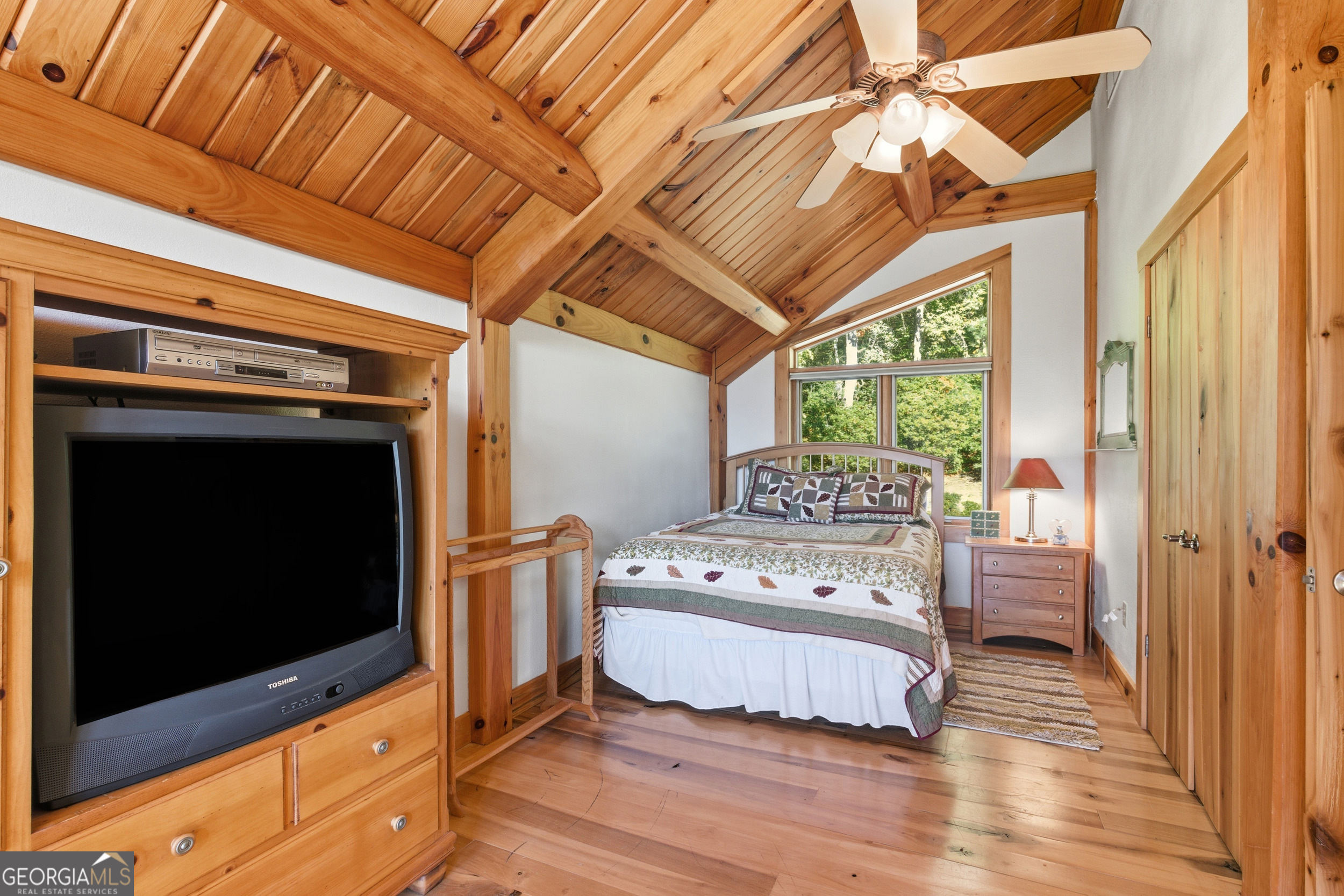 526 Grandaddy Still Road Scaly Mountain, NC 28775 - Photo 32 of 65 a living room with a bed furniture and a flat tv screen