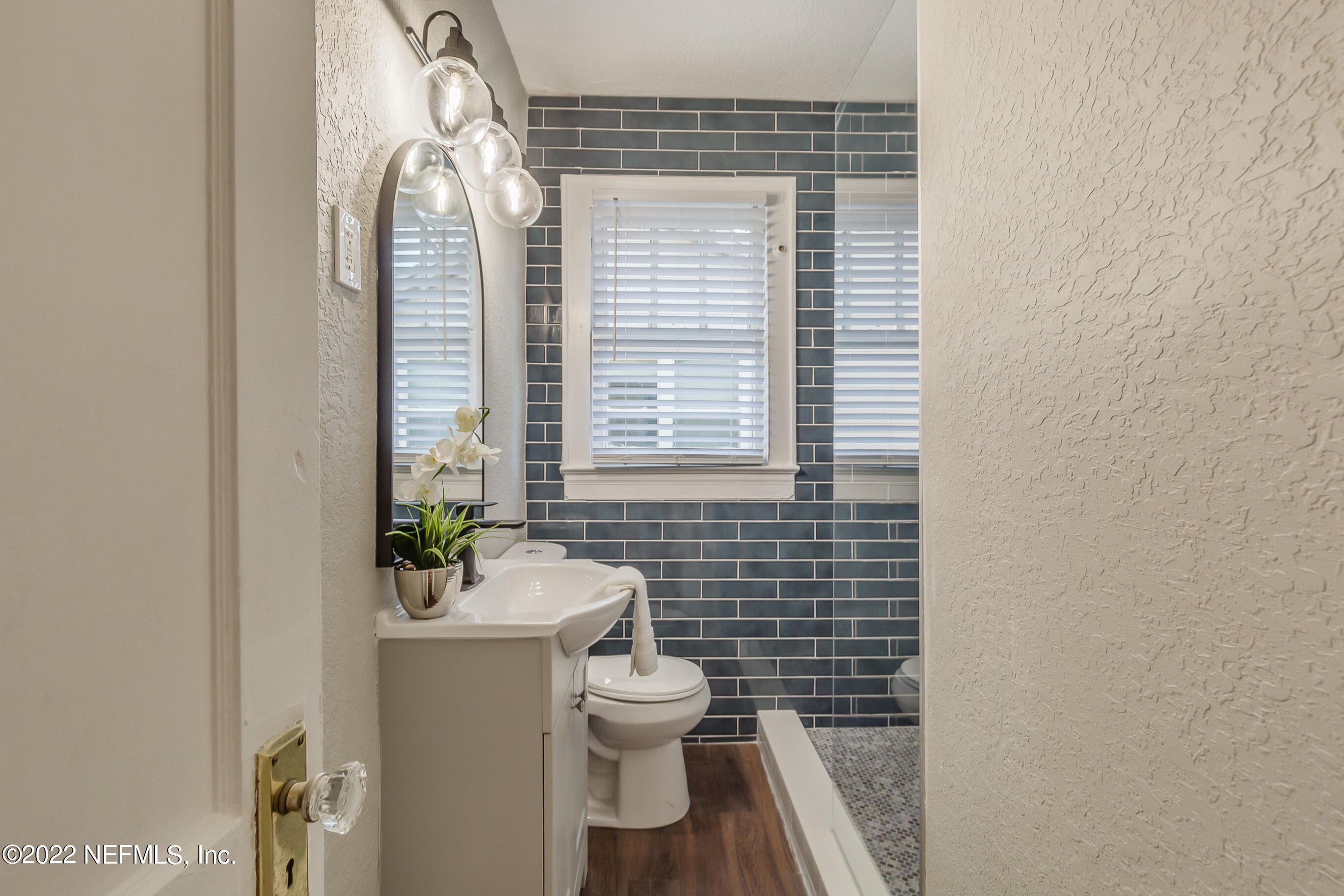 4012 Myra Street Jacksonville, FL 32205 - Photo 31 of 38 a bathroom with a toilet sink and mirror