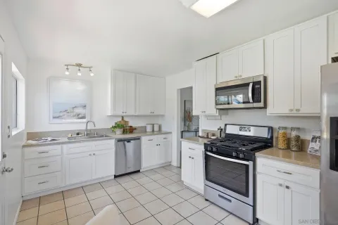 a kitchen with stainless steel appliances a sink stove and microwave