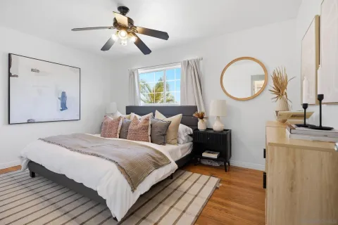 a bedroom with bed and wooden floor