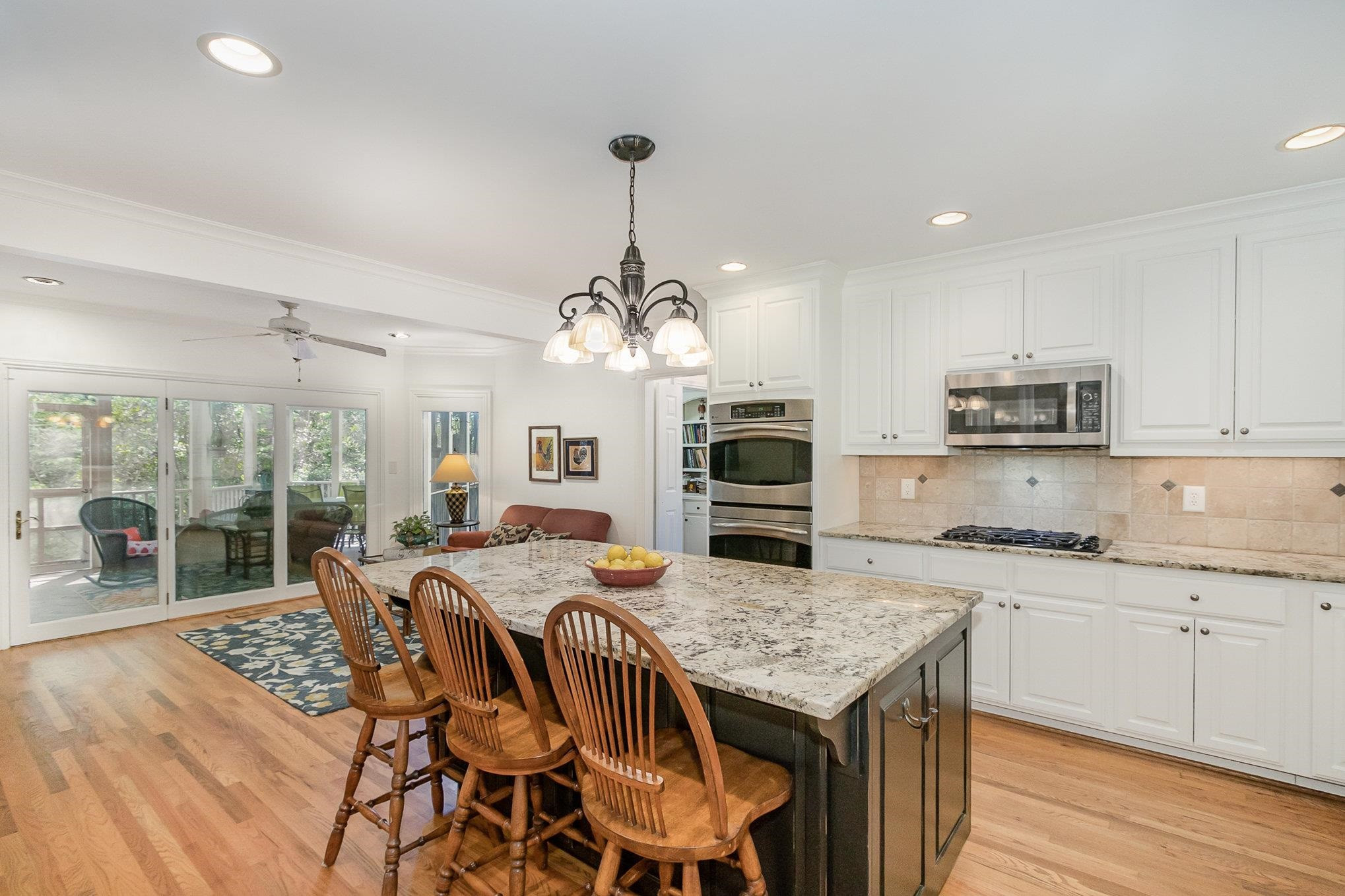 3327 Landor Road Raleigh, NC 27609 - Photo 26 of 60 a open kitchen with granite countertop a stove a sink a dining table and chairs