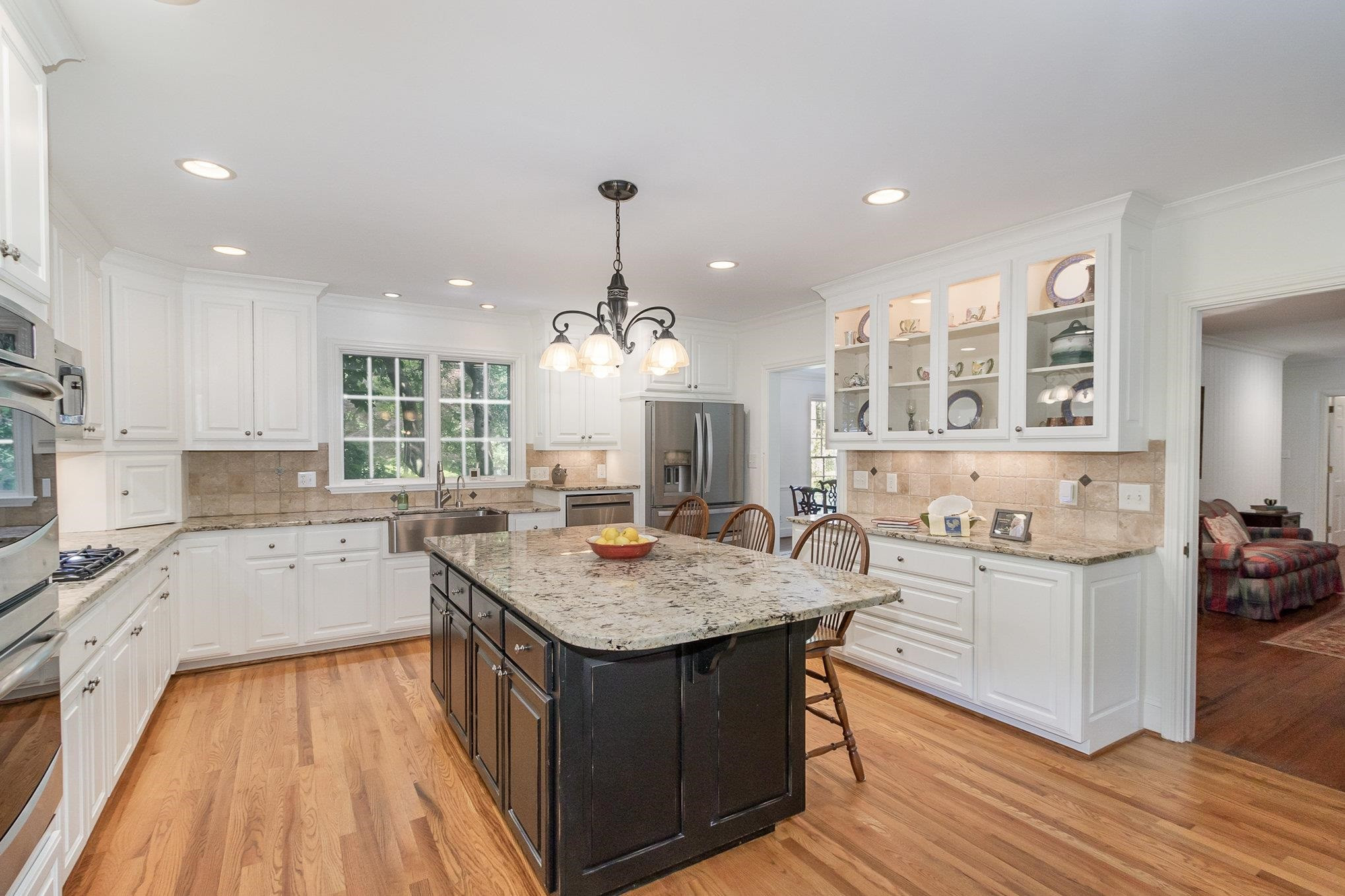 3327 Landor Road Raleigh, NC 27609 - Photo 28 of 60 a kitchen with a sink stove and wooden cabinets