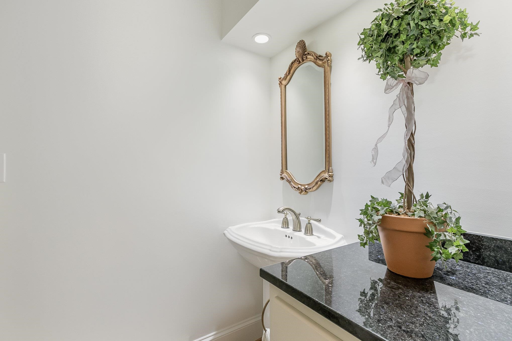 3327 Landor Road Raleigh, NC 27609 - Photo 31 of 60 a bathroom with a sink and a mirror